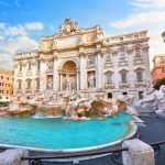 Trevi Fountain in Rome, Italy. Ancient fountain. Roman statues at piazza in old medieval city among traditional italian houses and street lamps. Famous landmark. Touristic destination for vacation.